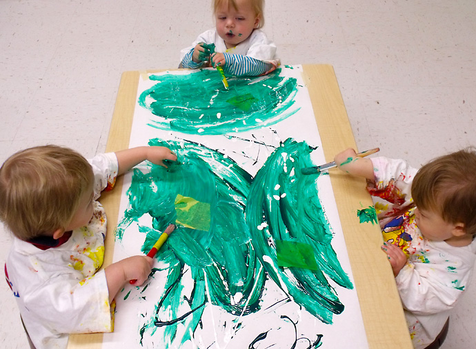 Toddlers paint in the Moonbeam room.